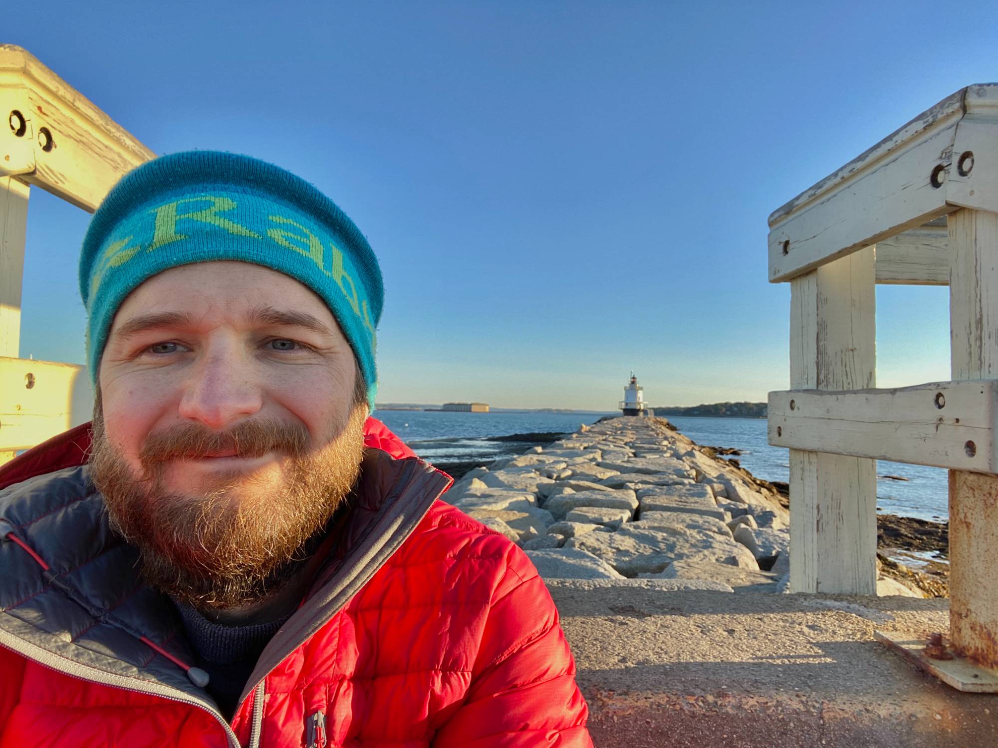 Michael Wicker in front of a light house smiling